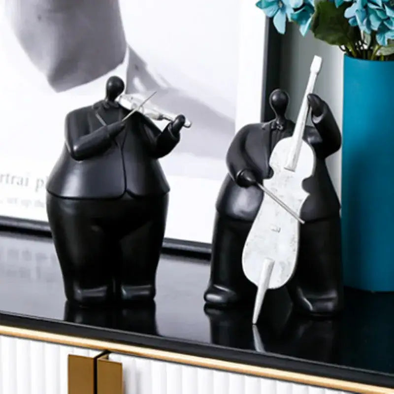 Black resin figurines of stylized musicians playing violin and cello modern musical instrument band decor