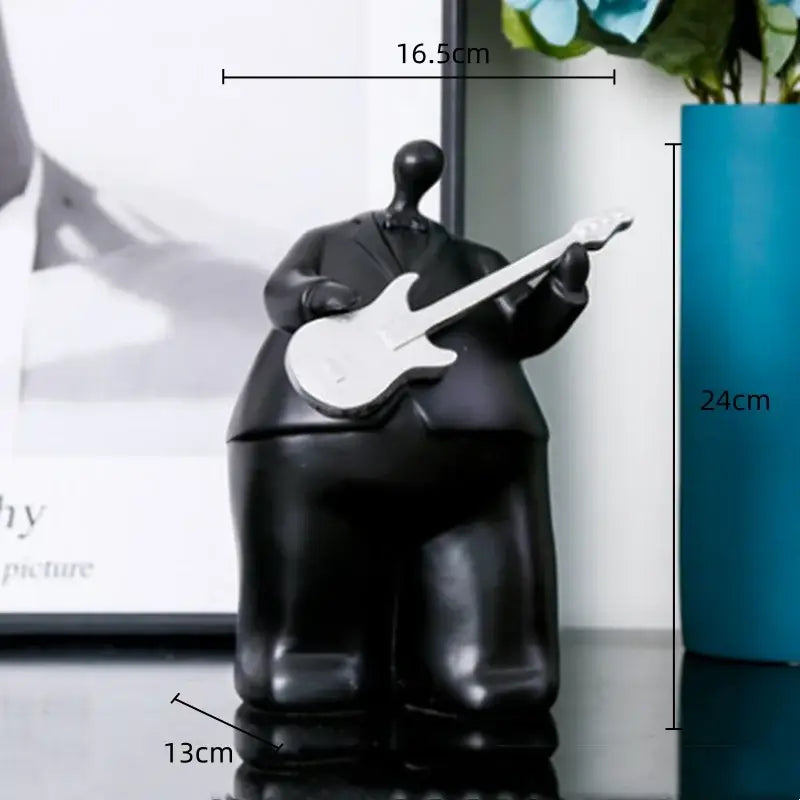 Modern black glossy resin musical instrument band figurine holding a white electric guitar for living room decor