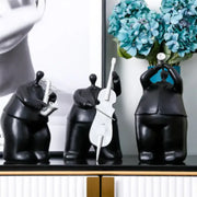 Set of three glossy black modern musical instrument band figurines featuring saxophone cello and trumpet players for decor