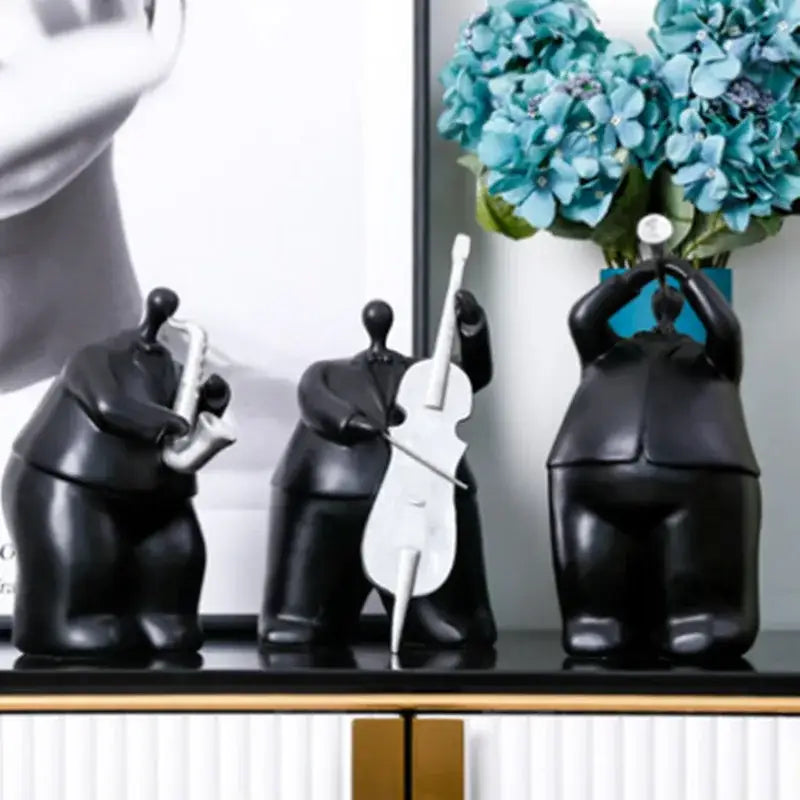 Set of three glossy black modern musical instrument band figurines featuring saxophone cello and trumpet players for decor