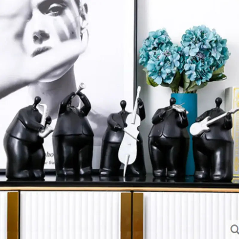 Set of five glossy black musical instrument band figurines featuring saxophone trumpet cello violin and electric guitar players for decor