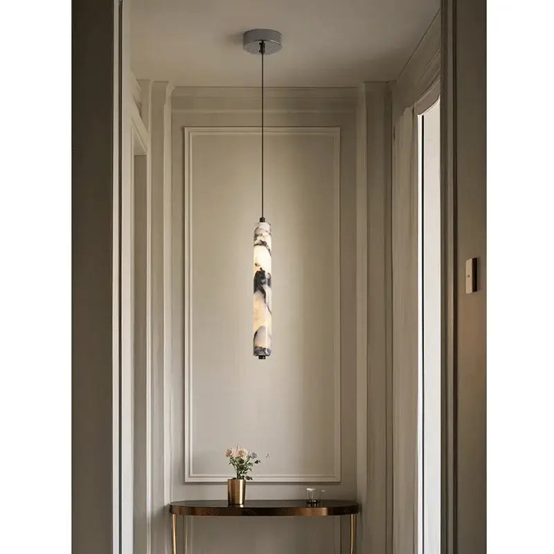 Modern black natural marble stone cylinder pendant light with a polished white and gray natural stone finish for kitchen