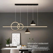 Modern black nordic designer dining pendant light with minimalist geometric circular and conical shades on sleek bar