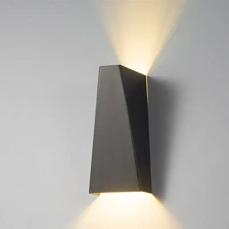 Modern black and off-white decorbites dual head led wall lamp with angular metal sconce casting warm light up and down