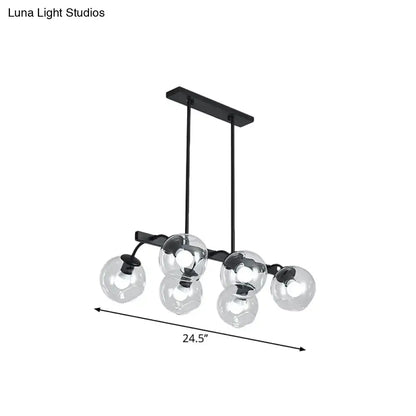 Black metal chandelier with five clear glass globe shades featuring a modern orb shade for kitchen and dining room use