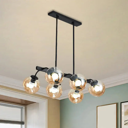 Modern black metal chandelier with five amber-tinted glass globe bulbs featuring orb shade for kitchen and dining room