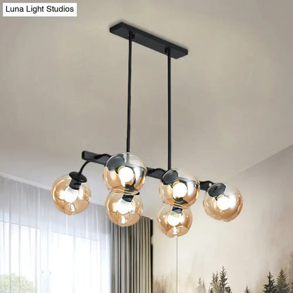 Modern black metal chandelier with five amber-tinted glass globe bulbs and orb shade for kitchen and dining room use