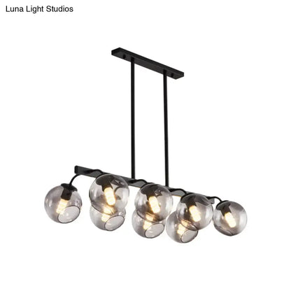 Black metal chandelier with six smoked glass globe orb shades for modern kitchen and dining room decor