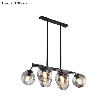 Black metal chandelier with four smoked glass globe orb shades for modern kitchen and dining room lighting