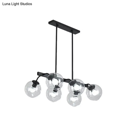 Black metal chandelier with five clear glass globe shades featuring a modern orb shade for kitchen and dining room