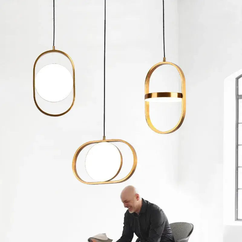 Three modern black pendant lights with gold oval frames and frosted glass panels by decorbites adjustable angle pendant light