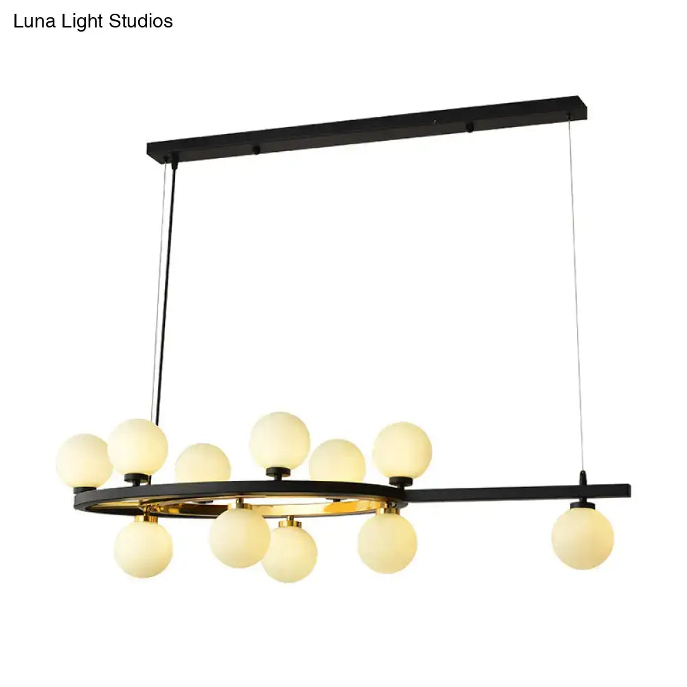 Modern black oval hanging light fixture chandelier with gold accents and frosted glass globe lights for dining room