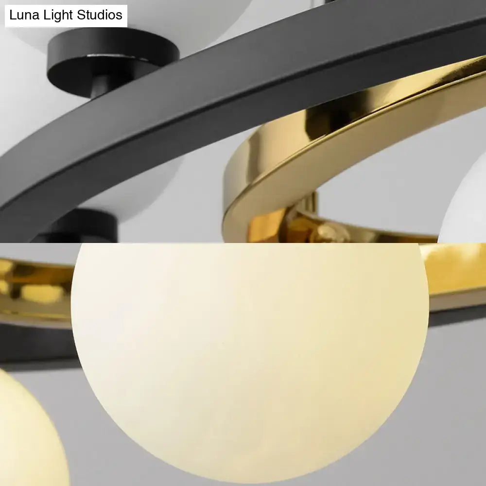 Modern black oval hanging light fixture featuring sleek black and gold metallic rings with frosted glass globes