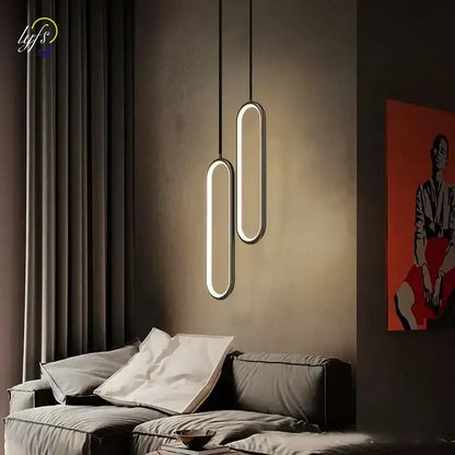 Modern black oval pendant light with led bulbs and a warm glow designed for dining room lighting