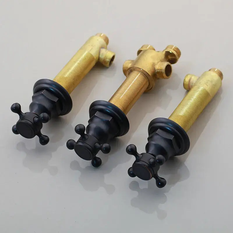 Three brass and black painting bathroom faucets with cross handles featuring modern water control valves