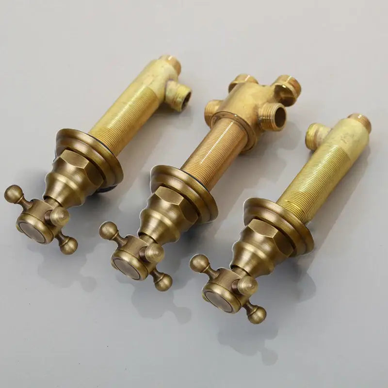 Three vintage-style brass bathroom faucets with ornate cross handles and threaded spouts water control valve design