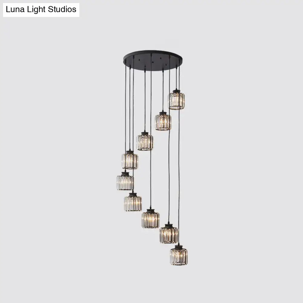 Modern black metal chandelier featuring cascading prismatic crystal cylindrical glass pendants for stairway lighting