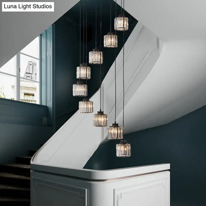 DecorBites™ modern prismatic crystal cylindrical pendant ceiling lights with dark metal fixtures hang above stairway