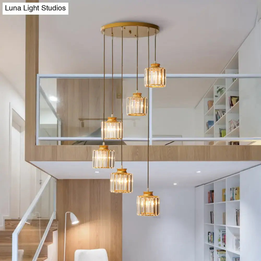 Gold-toned prismatic crystal cylindrical pendant ceiling lights with faceted glass shades for stairway lighting