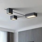 Modern black rectangular led ceiling light with two square and one elongated illuminated panels for living room decor