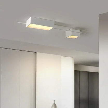 Modern black rectangular led ceiling lights with two white square lamps emitting warm illumination for living room decoration