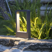 Modern black rectangular outdoor led lawn light with a glowing light panel for garden and landscape lighting