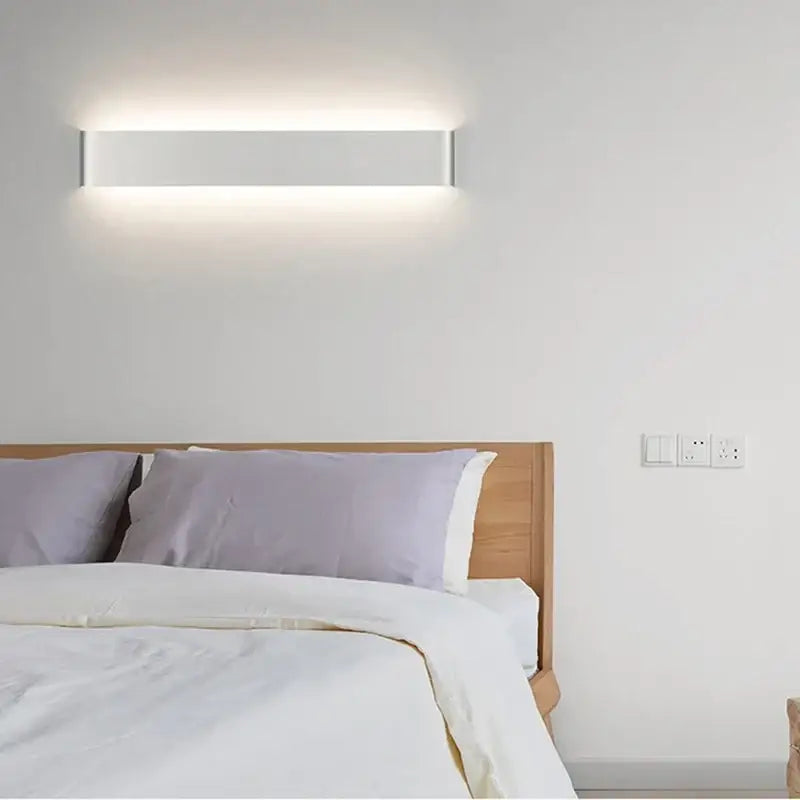 Modern black rectangular led wall lamp with sleek white minimalist design and subtle metallic edges for warm bedroom glow