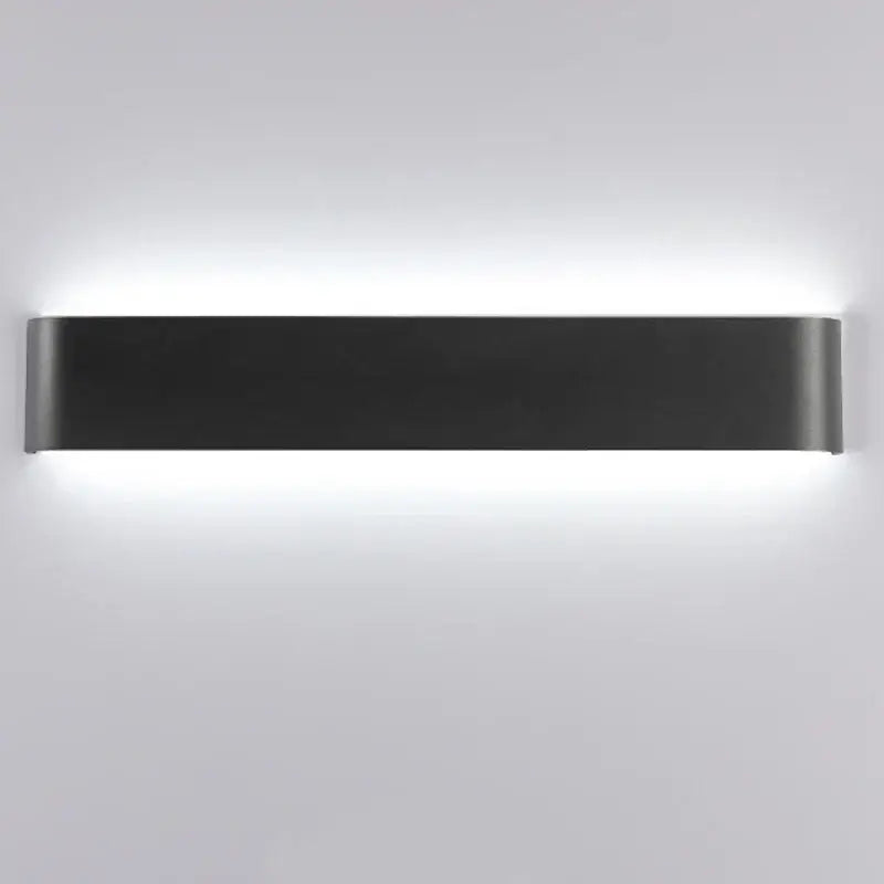 Modern black matte rectangular led wall lamp with sleek minimalist design providing warm glow for bedroom use