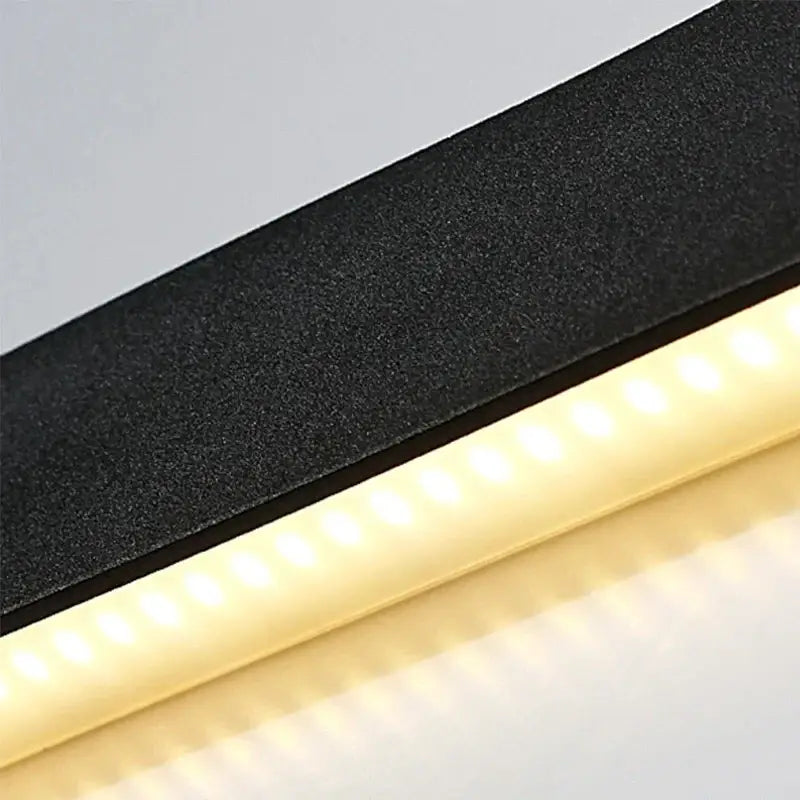 Modern black rectangular led wall lamp with textured surface and warm white illumination for bedroom use