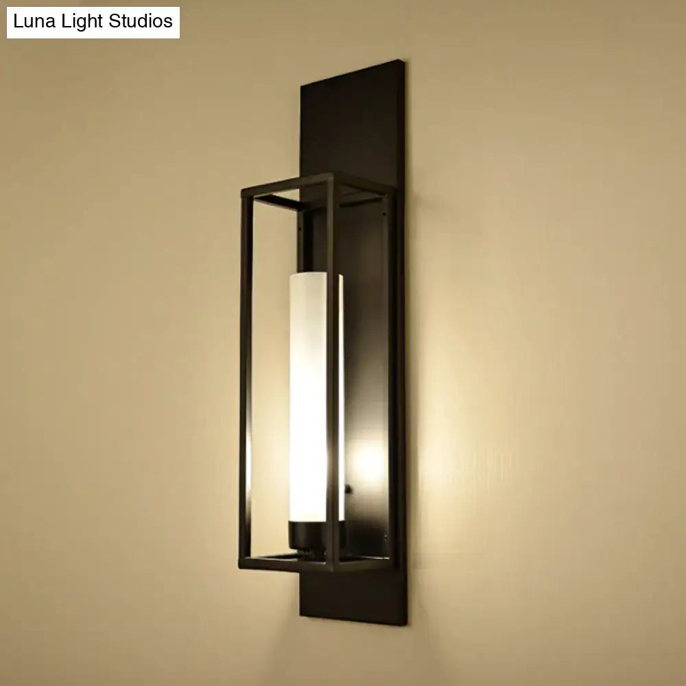 Modern black rectangular wall lamp with a sleek metal frame and cylindrical glass shade for living room lighting