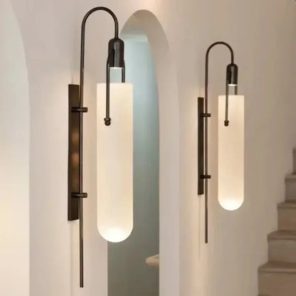 Two elegant matte black wall lamps with frosted glass shade led emit a warm glow as bedroom sconces