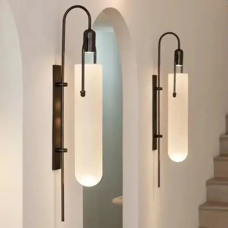 Two elegant matte black wall lamps with frosted glass shade led emit a warm glow as bedroom sconces