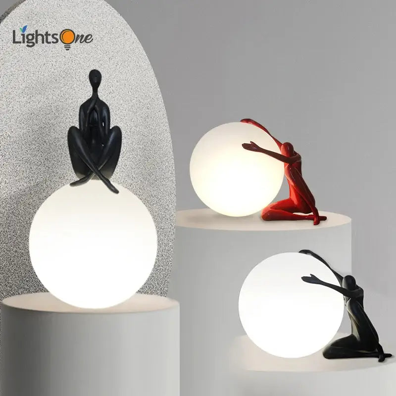 Modern black and red resin abstract humanoid table lamp with glowing white spherical ball holder for bedroom decorbites decor