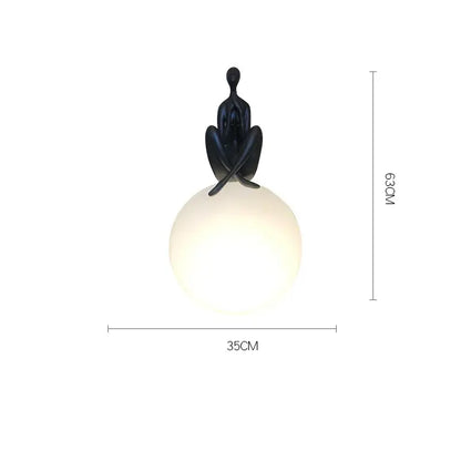 Modern black and red table lamp with a sculpted humanoid ball holder design for bedroom decorbites abstract decor