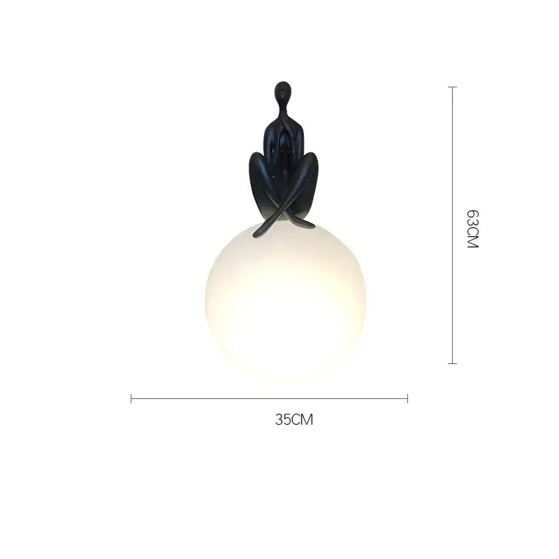 Modern black and red table lamp with a sculpted humanoid ball holder design for bedroom decorbites abstract decor