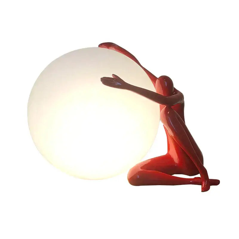Modern black and red decorbites abstract humanoid ball holder table lamp featuring a red glossy figurine holding a glowing white sphere