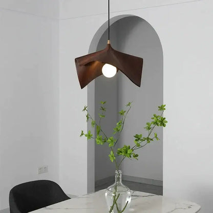 Dark brown wooden pendant chandelier with sleek sculpted design and central bulb for modern black resin led decorbites