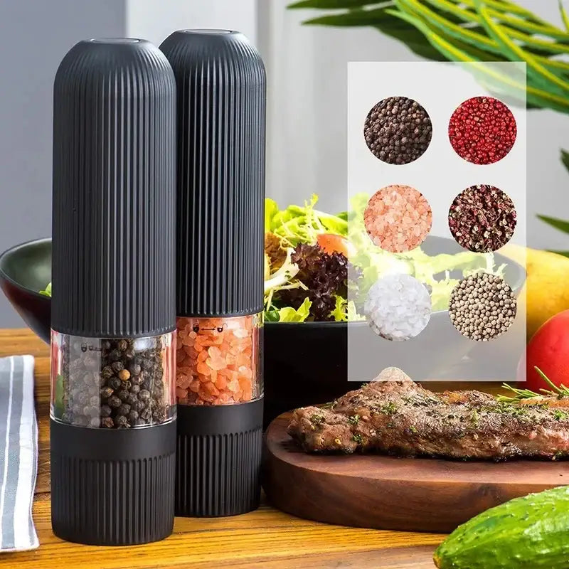Modern black ribbed automatic salt pepper grinder set with transparent glass revealing peppercorns and pink himalayan salt