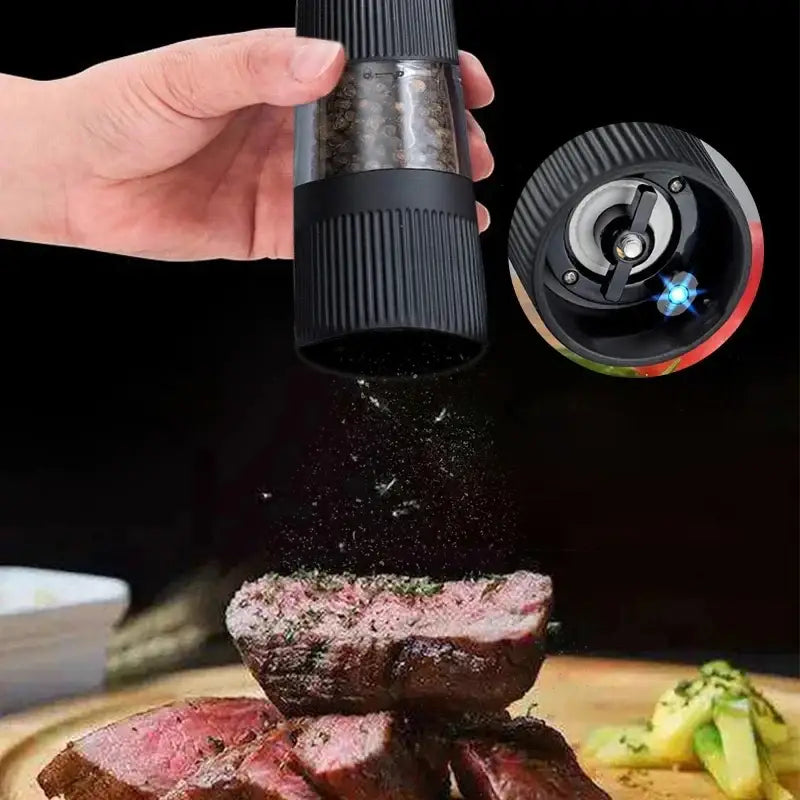 Modern black ribbed automatic salt pepper grinder with textured grip and transparent chamber filled with peppercorns