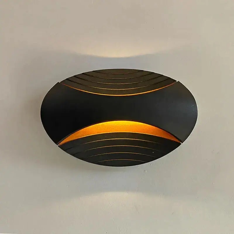 Modern black ribbed led wall lamp with curved design emitting warm amber light ideal for corridor lighting
