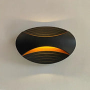 Modern black ribbed led wall lamp with curved design and warm amber light for corridor lighting