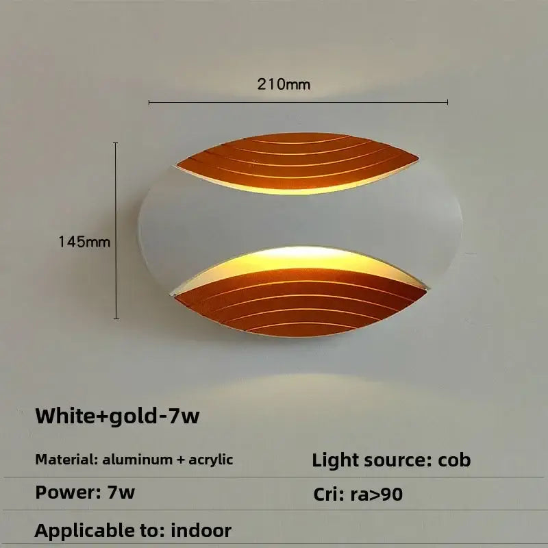 Modern white and gold oval aluminum and acrylic wall lamp with leaf design for corridor featuring warm amber led light