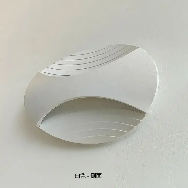 Modern white sleek curved led wall lamp with subtle linear grooves for warm amber corridor lighting