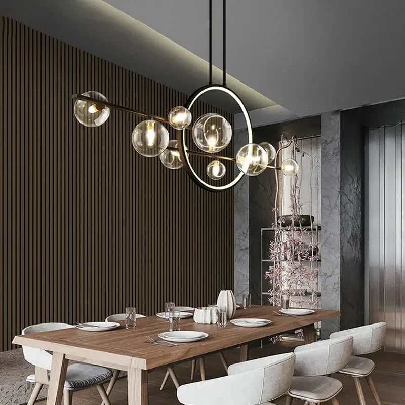 Modern black ring pendant light with glass globes and brass-toned arms perfect for dining room decorbites black ring
