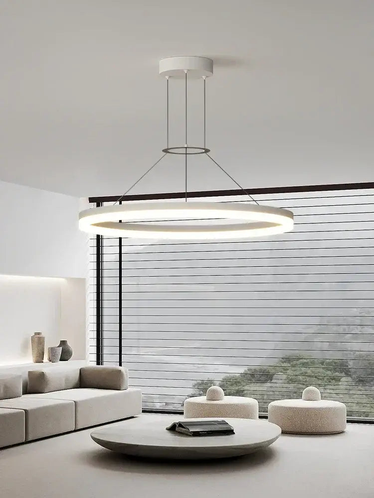Modern white circular pendant chandelier with thin metallic rods complementing decorbites black ring design