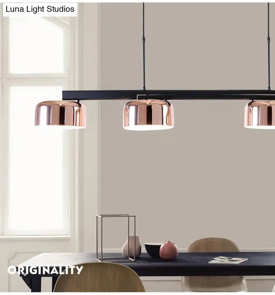 Modern black rose gold diner island lamp featuring three copper-finished dome pendant lights on a black bar