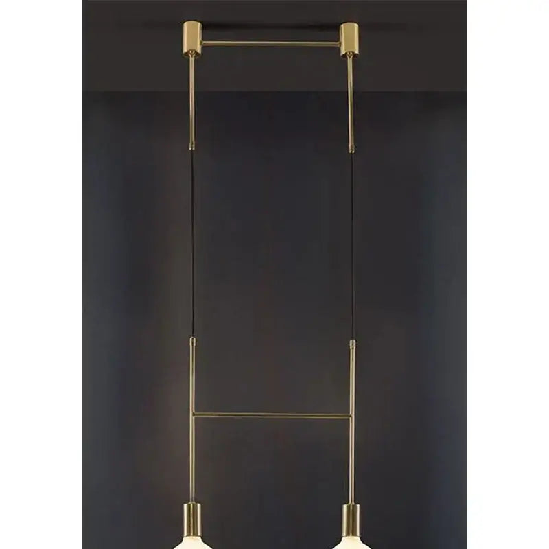 Modern black rose gold minimalist pendant light with brass rods and spherical glass shades for dining room decorbites black rose