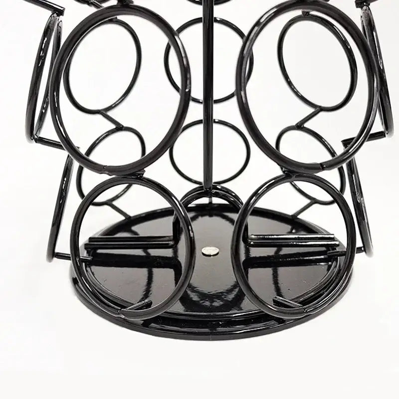 Modern black rotatable dolce gusto capsule rack made of metal wire with circular loops and glossy finish for kitchen storage