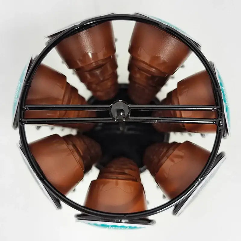Modern black rotatable metal capsule rack holding multiple brown dolce gusto capsules for kitchen storage by decorbites