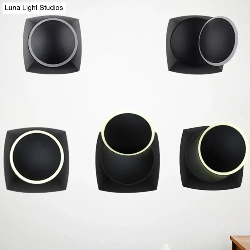 Modern black rotatable led wall sconce with square frame and circular illuminated interior for bedroom lighting